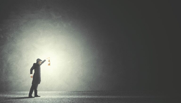 man shining light in the dark